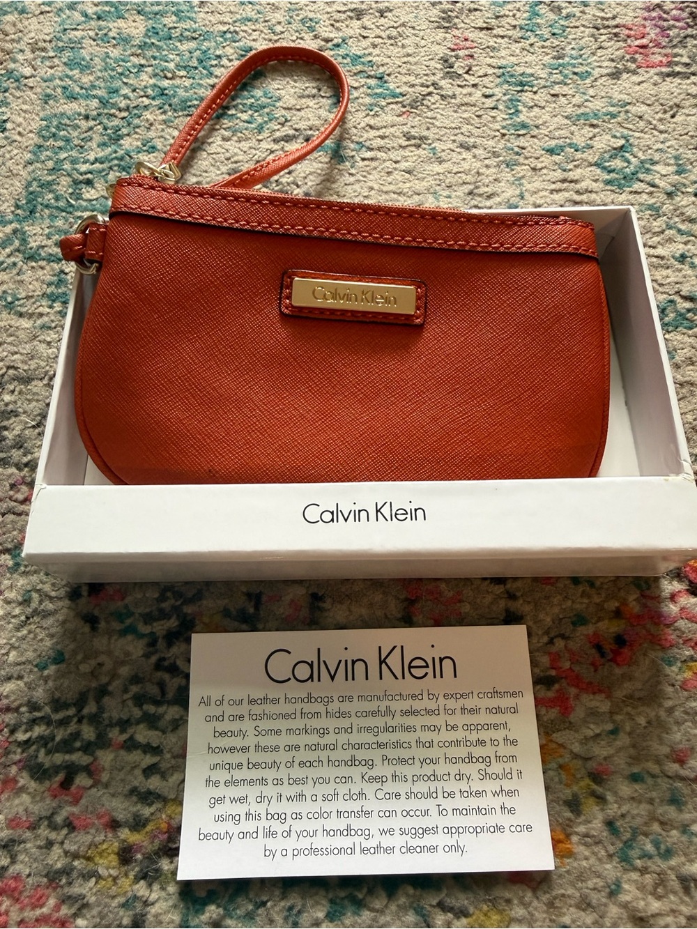 Calvin Klein Orange Wristlet with Gold Logo Plaque
